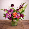 The combination of purple and orange flowers creates a harmonious and balanced