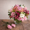 This elegant arrangement features a combination of pink and white flowers beautifully
