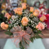 One dozen long stem peach roses with assorted greens and accent flower