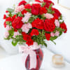 This gorgeous bouquet includes red roses, red carnations, light pink carnations, red