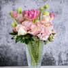 Beautiful seasonal pink flowers displayed in a gorgeous cut glass vase.