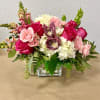 This Classy Low and Lush Arrangement includes Snapdragons, Roses, Hydrangeas, Bells of