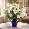 Stunning white arrangement in a cobalt blue vase.