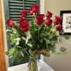 An arrangement of a dozen roses (or more) in a color of