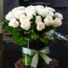 Two dozen premium white Roses, Cymbidium Orchid, in glass vase.