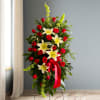 This Sympathy Standing Spray, in beautiful red, is a touching symbol of