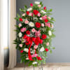 Our impressive standing spray arrangement, meticulously handcrafted by expert florists with crisp