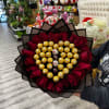 Bouquet with Ferreros chocolates and red roses, wrapped in floral paper