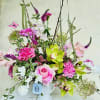 Embrace the beauty of spring with this elegant floral arrangement in soft
