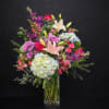 A lush, garden-inspired design overflowing with premium blooms. Soft hydrangeas, elegant lilies