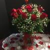 Stunning long stem red roses arranged in a vase with babys breath