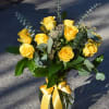 Dozen beautiful and sunshiny premium yellow roses arranged with lush foliage in
