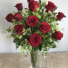 One dozen large, long stemmed red roses with lush velvety petals that