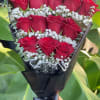 Premium red roses arranged in a romantic heart shape with delicate white
