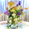 Beautiful assortment of wildflowers and garden flowers in a tall tapered container.