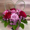 A romantic cube arrangement featuring premium red, pink, and lavender roses accented
