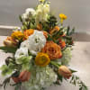 beautiful 
white lisianthus ,
ranunculus,
 tulips spray roses orange,
 Helleborus, 
green hydrangeas
blue Barrys