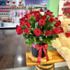 Express your love with fifty long-stem roses with greens and a red