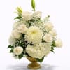 An elegant and sophisticated floral centerpiece designed in a classic gold pedestal