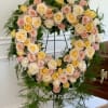 This fresh heart shaped wreath arrangement has an elegant garden style look
