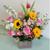 This beautiful garden arrangement with Sunflowers, Tulips, Roses and Alstroemeria is sure