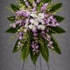 A lovely standing spray of purple dendrobium orchids complete with graceful white