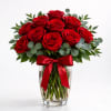 Our signature dozen red roses arranged in a sleek rose vase, designed
