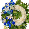 Heart-shaped wreath of blue and white roses with lilies and greenery