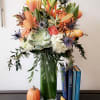 Amazing fall flowers set in a tall glass vase accent with fall