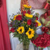 Red roses and sunflowers with mix flowers may not look exactly like