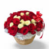 Red and white roses beautifully arranged in a classic woven basket, symbolizing