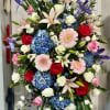 Sympathy spray with designers choice of flowers and colors in a tasteful