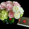 Floral arrangement crafted with seasonal blooms in same color  and container.
If
