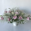 A simple, modern arrangement of pink lisianthus and baby's breath. This floral