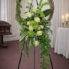Funeral wreath adorned with delicate white flowers and lush greenery, symbolizing peace