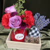 Pretty red and purple flowers in a red vase with lavender, heart