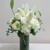 A nice combination of all white flowers including, roses, lilies hydrangea and