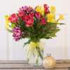 Clear Vase Of Mixed Colors of  Alstroemeria Lilies. Tied with a