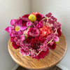 is a low-profile Valentine&rsquo;s arrangement designed in rich, dark tones with a