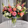 Introducing a stunning floral arrangement in a tall vase, designed to elevate