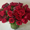 A stunning arrangement of 36 select red roses, artfully designed in a