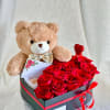 A velvet box filled with fresh roses, paired with a cute teddy