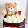 A velvet box filled with fresh roses, paired with a cute teddy