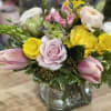 A sweet array of pink, yellow and green spring blooms in a