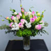 A breathtaking tall arrangement featuring delicate blush pink roses, graceful white lilies