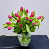 A vibrant and modern arrangement featuring bold pink tulips nestled above lush