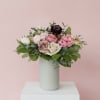 Full bouquet of seasonal blooms &amp; foliage in a ceramic vase.