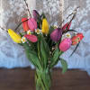 This bright mix color bouquet of tulips will bring sunshine and smiles.