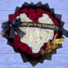 48 red roses arranged in a heart shape, wrapped in black paper