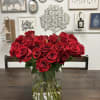 50 Red Roses arranged in a clear vase.